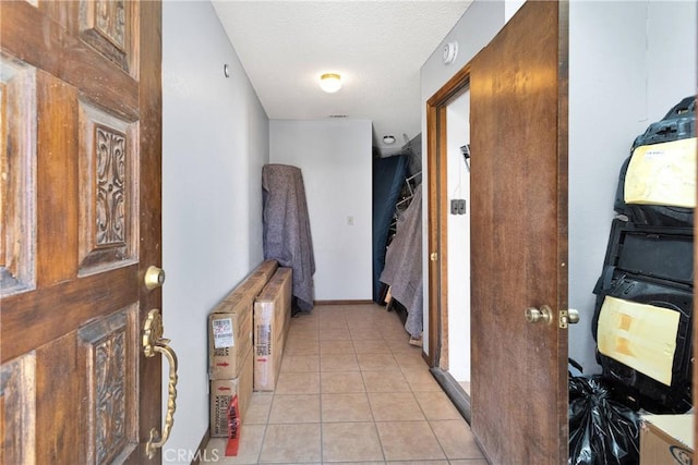 19678 Red Feather Rd, Apple Valley, CA 92307 - hallway with light tile patterned floors and a textured ceiling