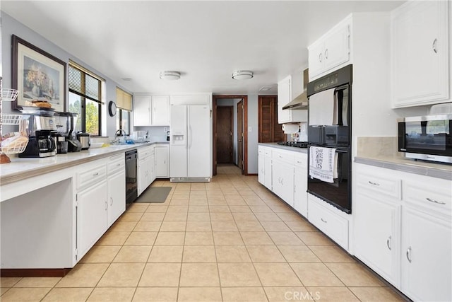 19678 Red Feather Rd, Apple Valley, CA 92307 - kitchen with black appliances, wall chimney exhaust hood, white cabinets, light tile patterned floors, and light countertops