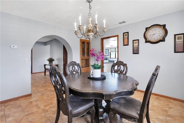 19678 Red Feather Rd, Apple Valley, CA 92307 - dining area with arched walkways and a chandelier