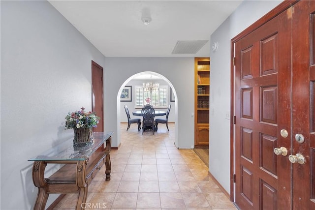 19678 Red Feather Rd, Apple Valley, CA 92307 - entryway featuring a chandelier, arched walkways, and light tile patterned floors