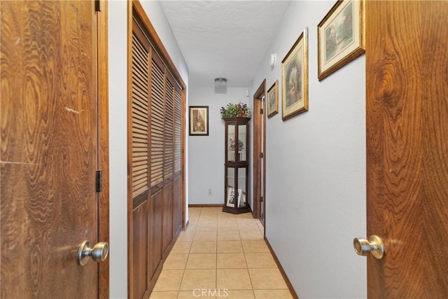 19678 Red Feather Rd, Apple Valley, CA 92307 - hallway with light tile patterned flooring and a textured ceiling