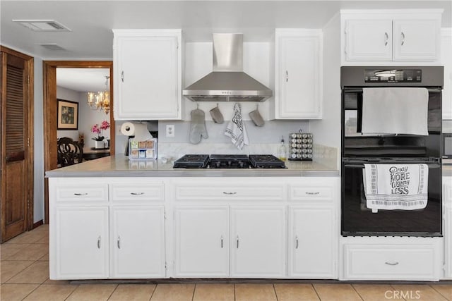 19678 Red Feather Rd, Apple Valley, CA 92307 - kitchen featuring wall chimney range hood, a chandelier, white cabinets, and light countertops