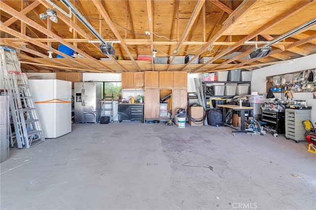 19678 Red Feather Rd, Apple Valley, CA 92307 - garage featuring stainless steel fridge and freestanding refrigerator