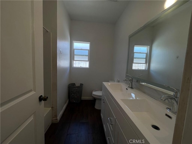 1012 Feliz Dr, Bakersfield, CA 93307 - bathroom featuring healthy amount of natural light, double vanity, and wood finished floors