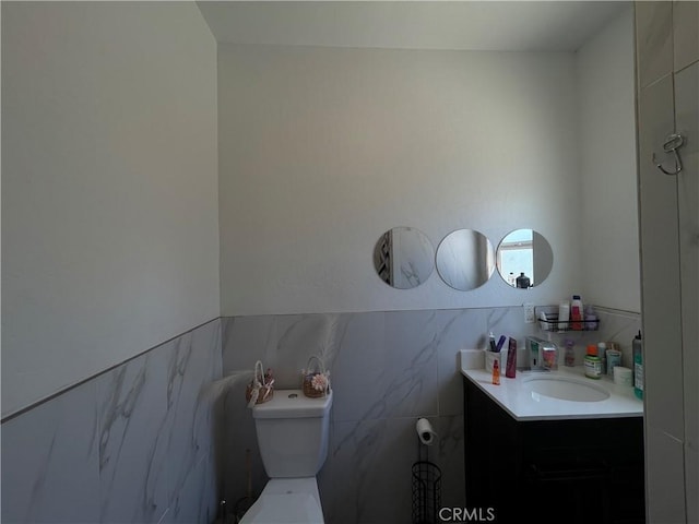 1012 Feliz Dr, Bakersfield, CA 93307 - bathroom with vanity, tile walls, and a wainscoted wall
