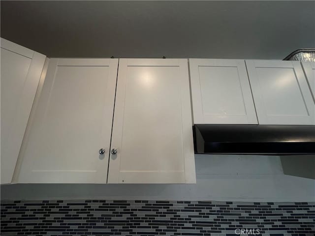1012 Feliz Dr, Bakersfield, CA 93307 - detailed view of wall chimney range hood and white cabinets