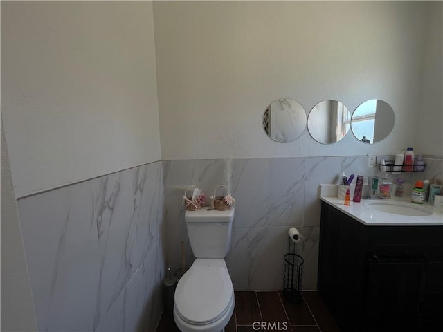 1012 Feliz Dr, Bakersfield, CA 93307 - half bath with vanity, tile walls, and a wainscoted wall
