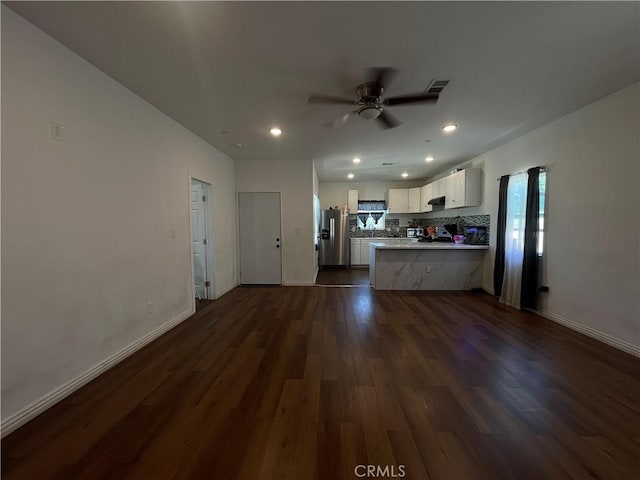 1012 Feliz Dr, Bakersfield, CA 93307 - unfurnished living room with dark wood-type flooring, ceiling fan, and recessed lighting