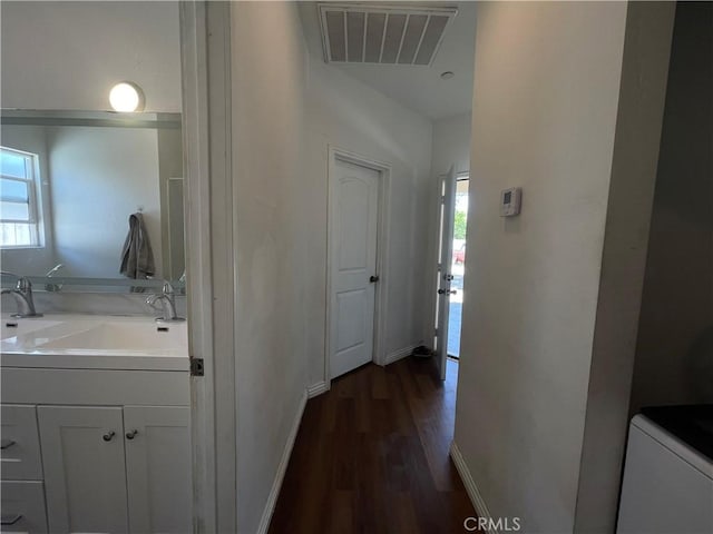 1012 Feliz Dr, Bakersfield, CA 93307 - hall featuring a sink and dark wood-style flooring