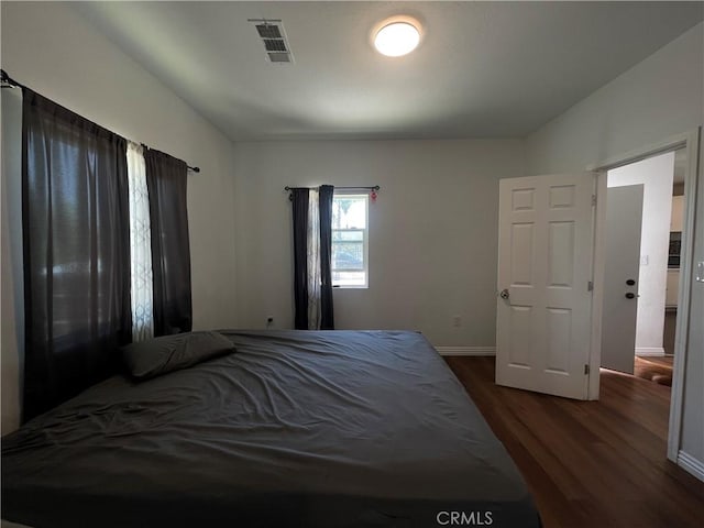 1012 Feliz Dr, Bakersfield, CA 93307 - bedroom with dark wood-style floors and baseboards