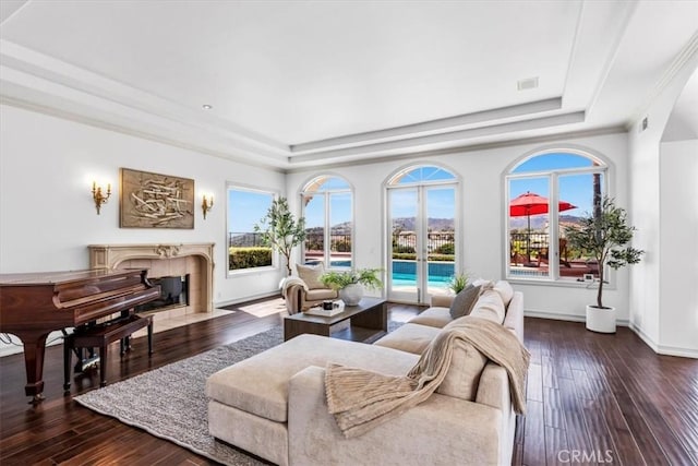5 Marbella, Dana Point, CA 92629 - living room featuring a tray ceiling, healthy amount of natural light, a tile fireplace, and crown molding
