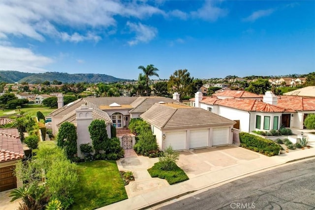 5 Marbella, Dana Point, CA 92629 - mediterranean / spanish home with a garage, concrete driveway, a residential view, a mountain view, and a tiled roof
