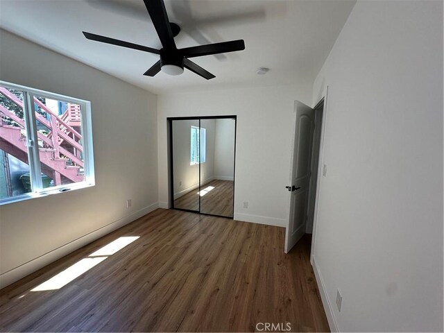 1253 W 65th St, Los Angeles, CA 90044 - unfurnished bedroom with wood finished floors, a closet, and a ceiling fan
