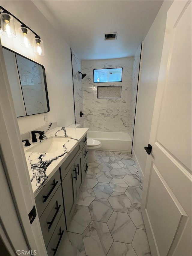1253 W 65th St, Los Angeles, CA 90044 - bathroom featuring vanity, marble look tiles, and washtub / shower combination