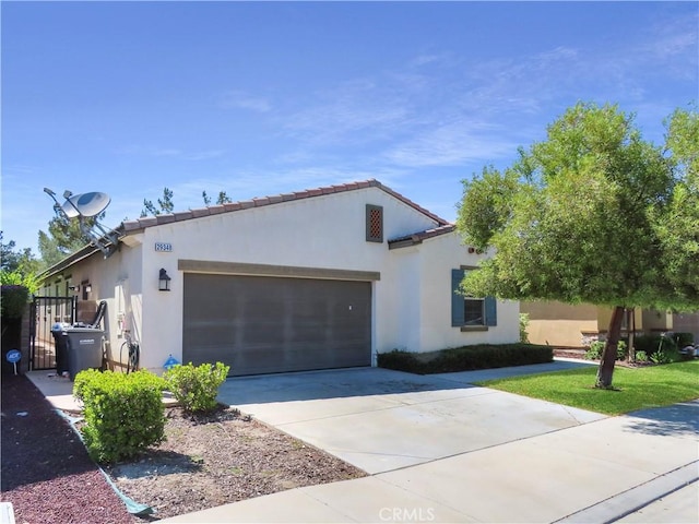 29348 Tournament, Lake Elsinore, CA 92530 - mediterranean / spanish-style home with a garage, driveway, and stucco siding