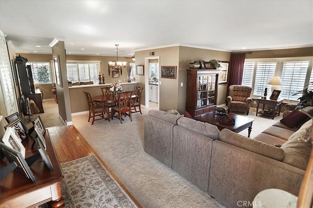 22669 Pamplico Dr, Saugus, CA 91350 - living area with a chandelier, crown molding, light carpet, healthy amount of natural light, and recessed lighting