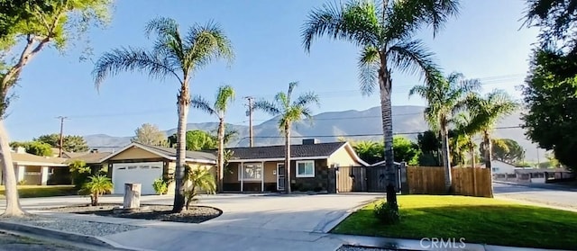 604 Sequoia St, San Bernardino, CA 92407 - ranch-style home with concrete driveway, a mountain view, and a garage