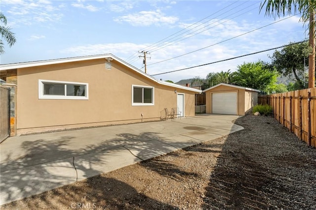 604 Sequoia St, San Bernardino, CA 92407 - view of side of property with driveway, stucco siding, a fenced backyard, and a garage