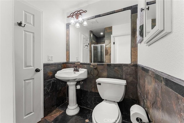 604 Sequoia St, San Bernardino, CA 92407 - bathroom featuring tile walls, a shower stall, and a wainscoted wall
