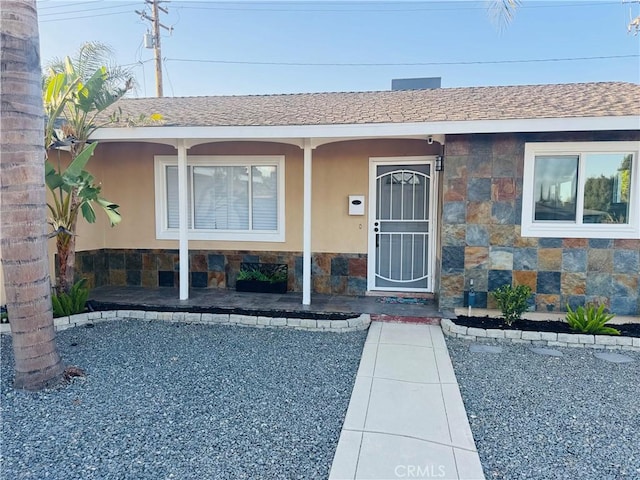 604 Sequoia St, San Bernardino, CA 92407 - entrance to property with stone siding, roof with shingles, and stucco siding