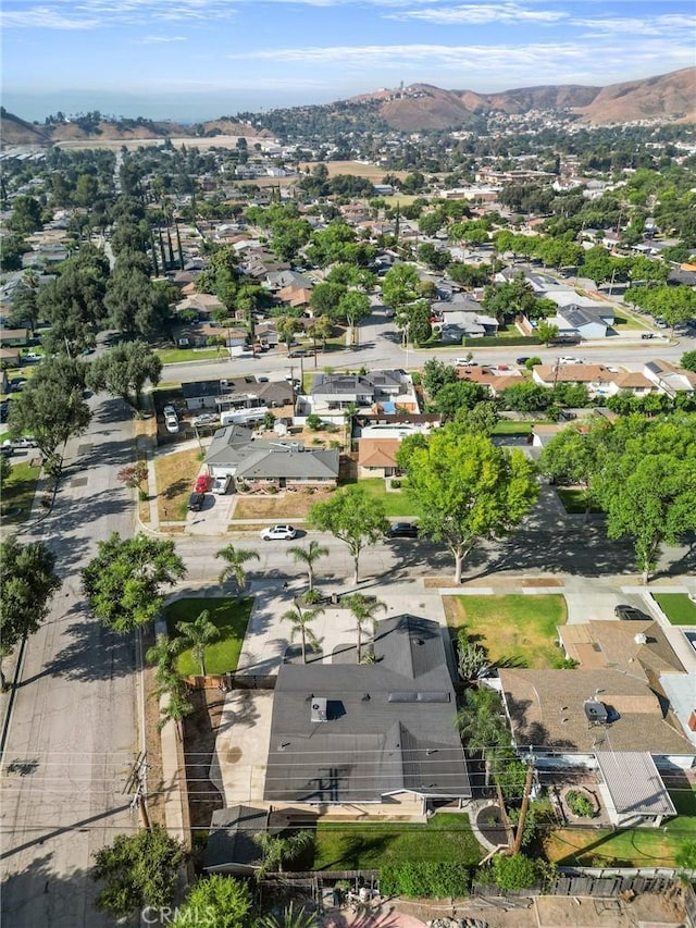 604 Sequoia St, San Bernardino, CA 92407 - aerial overview of property's location featuring a mountain backdrop and nearby suburban area