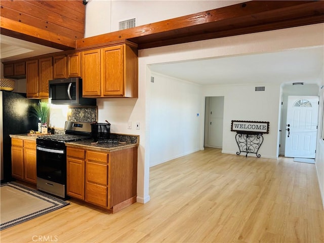604 Sequoia St, San Bernardino, CA 92407 - kitchen featuring appliances with stainless steel finishes, light wood-style floors, brown cabinets, and tasteful backsplash