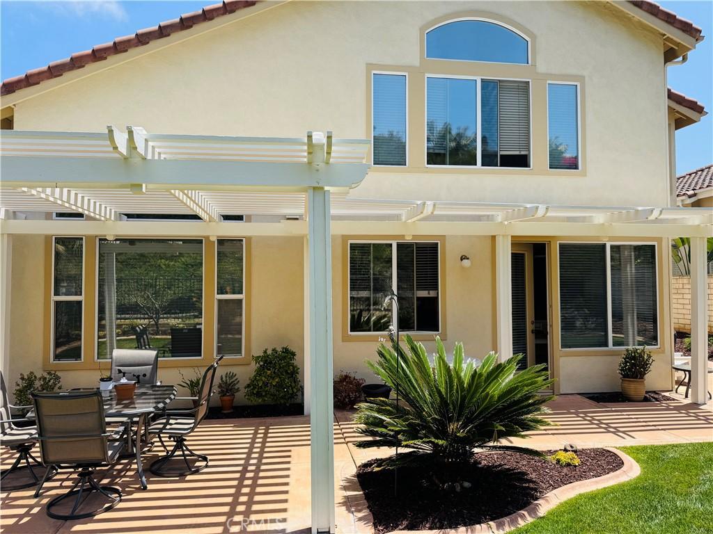 7004 Wildrose Ter, Carlsbad, CA 92011 - rear view of house with a pergola, stucco siding, and a patio