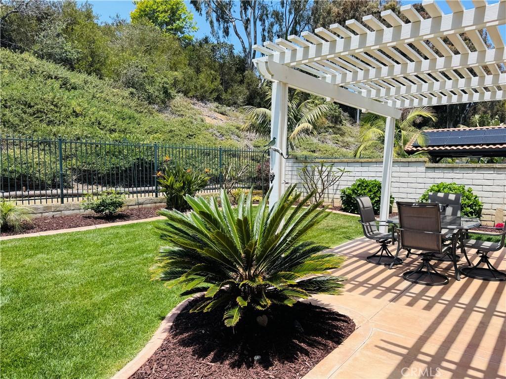 7004 Wildrose Ter, Carlsbad, CA 92011 - fenced backyard featuring outdoor dining space, a pergola, and a patio
