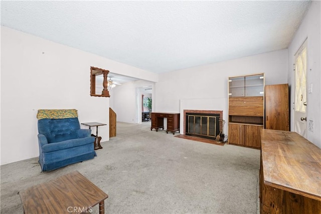 631 N Evergreen St, Burbank, CA 91505 - unfurnished living room featuring carpet, a brick fireplace, a ceiling fan, and a textured ceiling