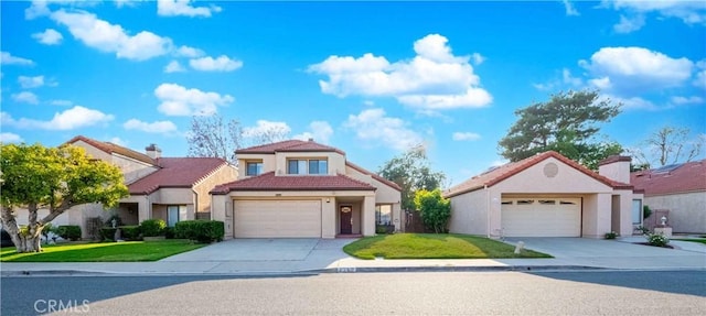 2383 Hampton Ave, Simi Valley, CA 93063 - mediterranean / spanish-style house with driveway, a garage, and a tile roof