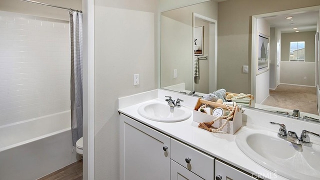 30753 Viper Ct, Winchester, CA 92596 - bathroom featuring double vanity, shower / bath combo with shower curtain, and wood finished floors