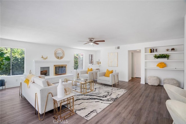 7029 Novara Pl, Rancho Cucamonga, CA 91701 - living room with a ceiling fan, wood finished floors, a fireplace, and built in shelves