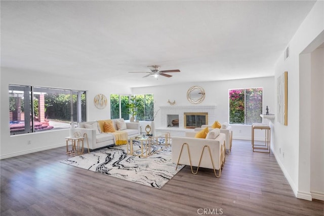 7029 Novara Pl, Rancho Cucamonga, CA 91701 - living room featuring plenty of natural light, wood finished floors, ceiling fan, and a brick fireplace