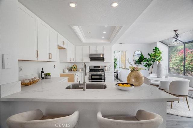 7029 Novara Pl, Rancho Cucamonga, CA 91701 - kitchen featuring stainless steel gas range oven, a peninsula, light stone countertops, white cabinets, and recessed lighting