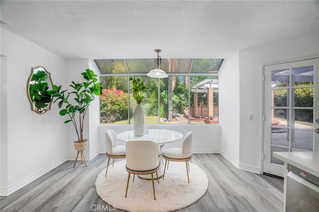 7029 Novara Pl, Rancho Cucamonga, CA 91701 - dining area with light wood-style flooring and a textured ceiling