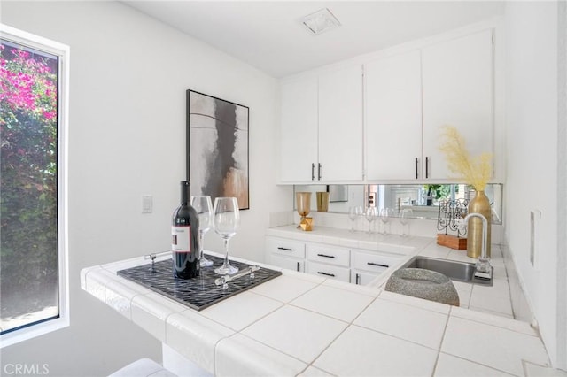7029 Novara Pl, Rancho Cucamonga, CA 91701 - kitchen featuring tile countertops and white cabinets