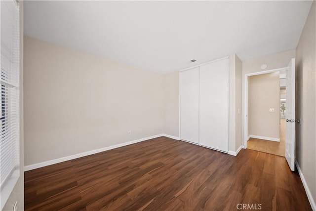 2988 Dartmouth Cir, Corona, CA 92879 - unfurnished bedroom featuring dark wood finished floors and a closet
