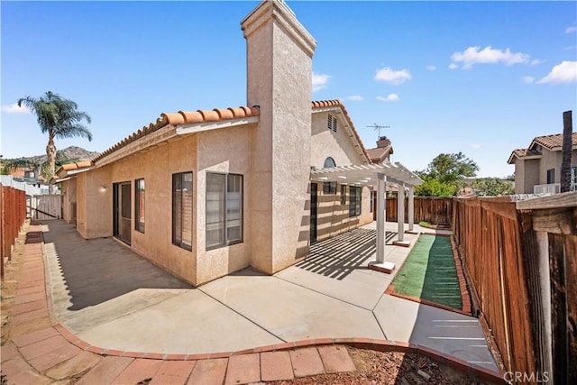 2988 Dartmouth Cir, Corona, CA 92879 - view of property exterior featuring a pergola, a fenced backyard, a patio, stucco siding, and a tiled roof