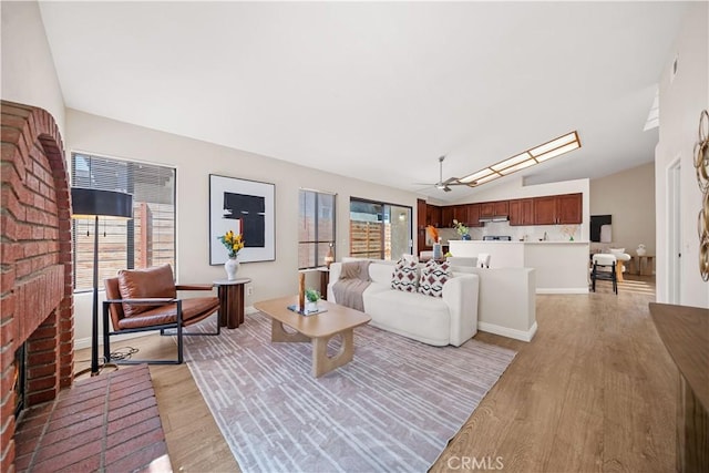 2988 Dartmouth Cir, Corona, CA 92879 - living area with light wood-style floors, a fireplace, lofted ceiling, and a ceiling fan