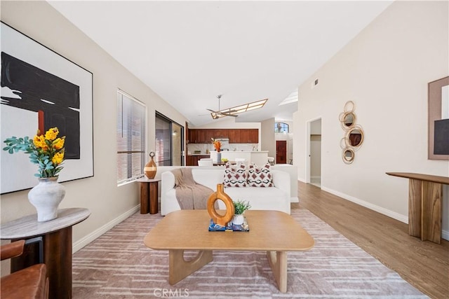 2988 Dartmouth Cir, Corona, CA 92879 - living room featuring lofted ceiling, light wood-style floors, healthy amount of natural light, and a chandelier