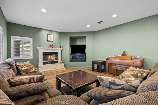 15355 Michael Crest Dr, Canyon Country, CA 91387 - living area with wood finished floors, recessed lighting, a glass covered fireplace, and built in features