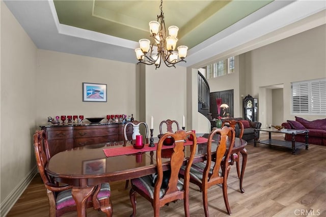 15355 Michael Crest Dr, Canyon Country, CA 91387 - dining space featuring a chandelier, wood finished floors, and a raised ceiling