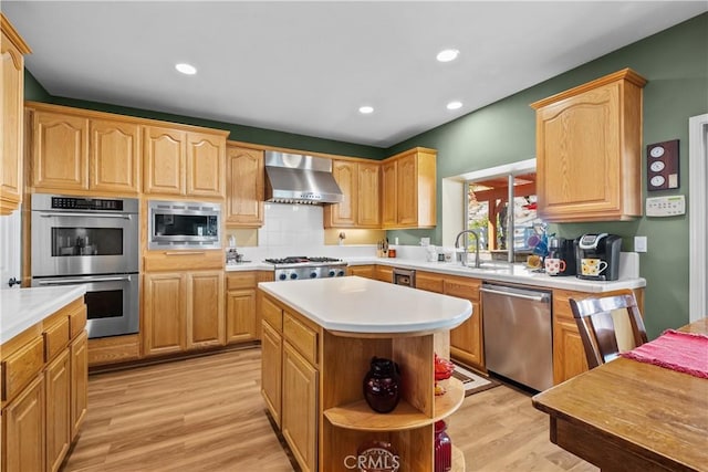 15355 Michael Crest Dr, Canyon Country, CA 91387 - kitchen with stainless steel appliances, wall chimney range hood, light wood finished floors, light countertops, and a center island