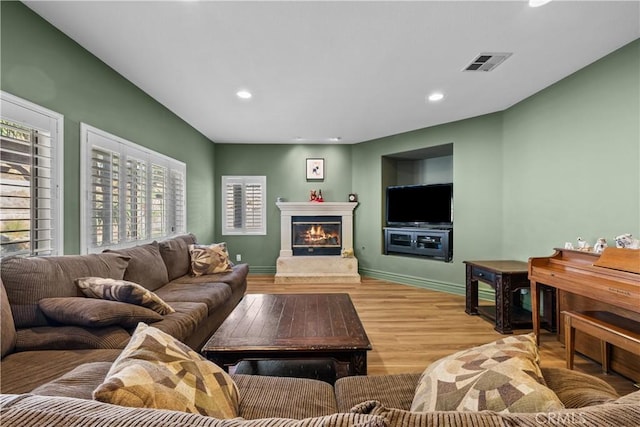 15355 Michael Crest Dr, Canyon Country, CA 91387 - living area with light wood-type flooring, a glass covered fireplace, and recessed lighting