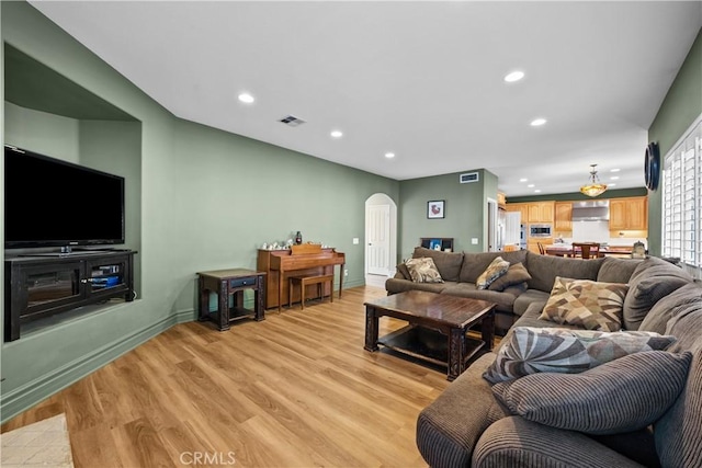 15355 Michael Crest Dr, Canyon Country, CA 91387 - living room with arched walkways, recessed lighting, and light wood finished floors