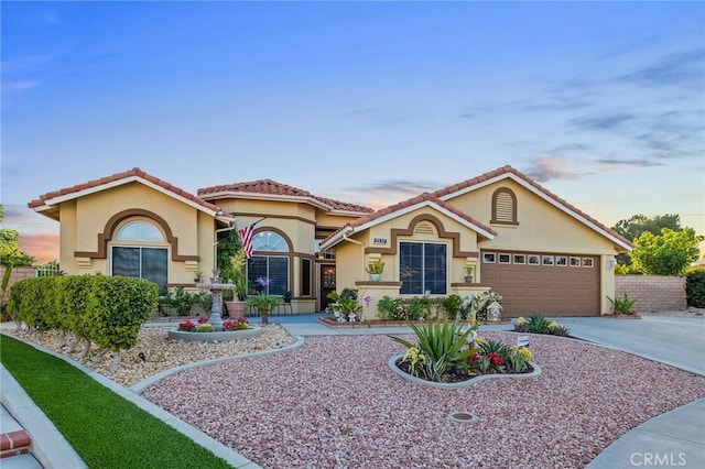 2157 Pecan Tree St, Hemet, CA 92545 - mediterranean / spanish house featuring stucco siding, an attached garage, driveway, and a tile roof