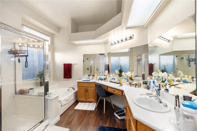 2157 Pecan Tree St, Hemet, CA 92545 - bathroom featuring a stall shower, vanity, a bath, and wood finished floors