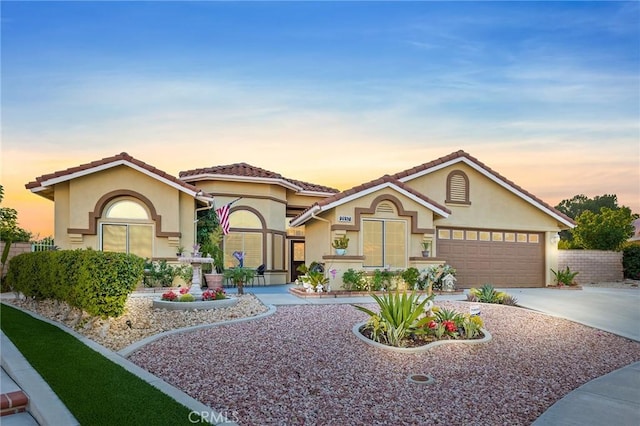 2157 Pecan Tree St, Hemet, CA 92545 - view of front facade featuring stucco siding, driveway, an attached garage, and a tiled roof