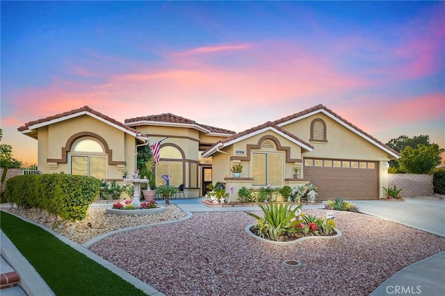 2157 Pecan Tree St, Hemet, CA 92545 - view of front of property with stucco siding, concrete driveway, a garage, and a tiled roof