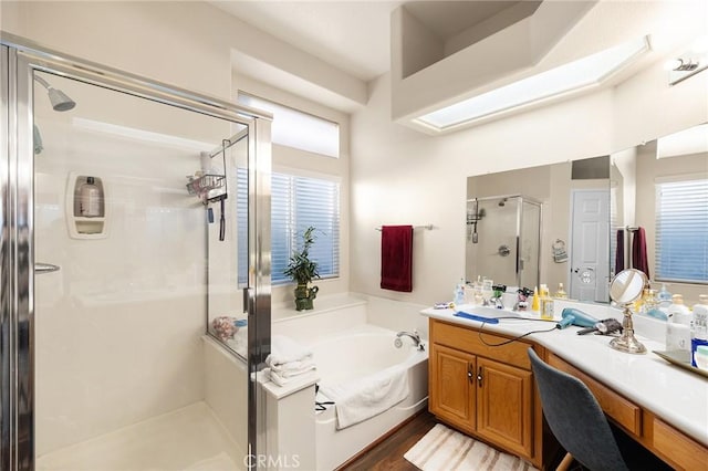 2157 Pecan Tree St, Hemet, CA 92545 - bathroom with vanity, a stall shower, a bath, and plenty of natural light